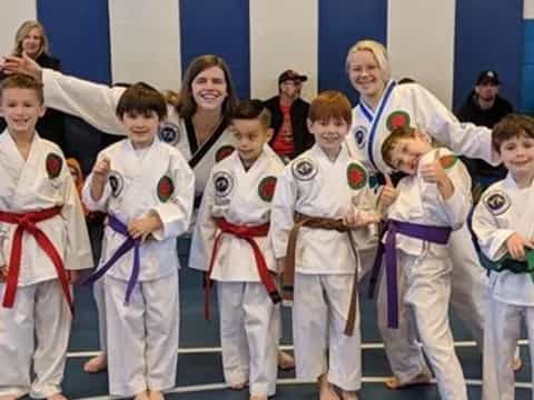 a group of children in karate uniforms