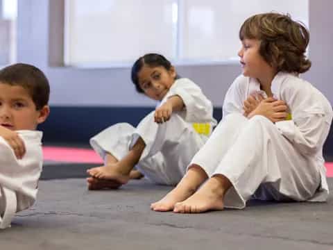 a person and two children sitting on the floor