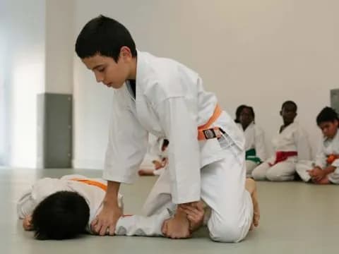 a man kneeling down to touch a boy's head