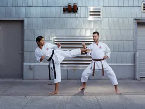 a man and woman in karate uniforms