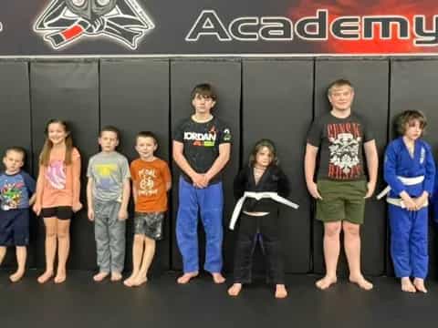 a group of people standing in front of a black wall