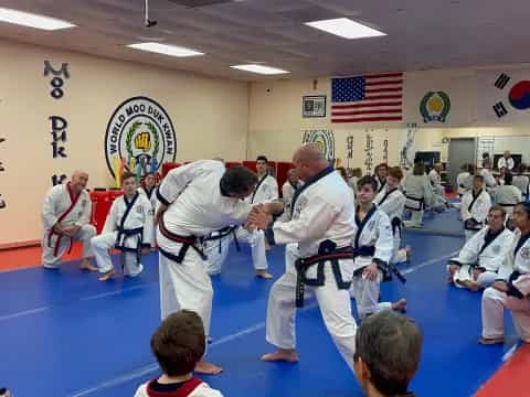 a group of people in karate uniforms
