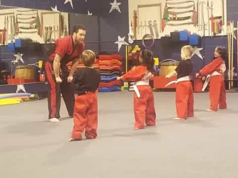 a group of people in red jumpsuits in a room