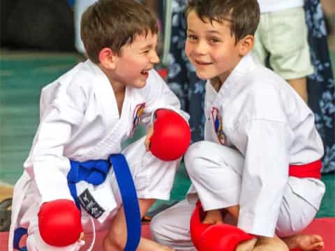 a couple of boys in karate uniforms