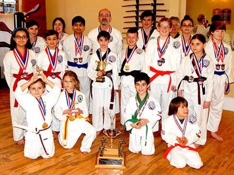 a group of people wearing medals and posing for a photo