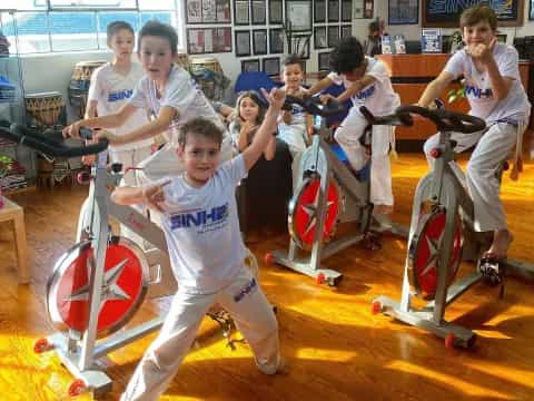 a group of people exercising on exercise equipment