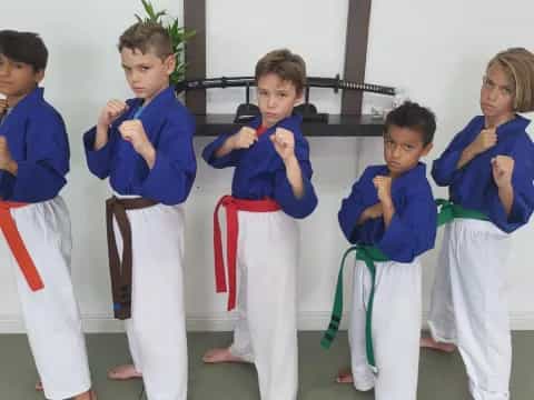 a group of kids in blue karate uniforms