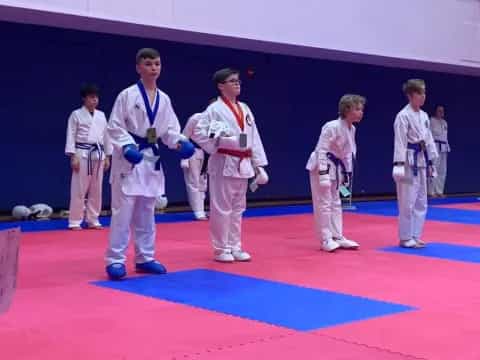 a group of people in karate uniforms