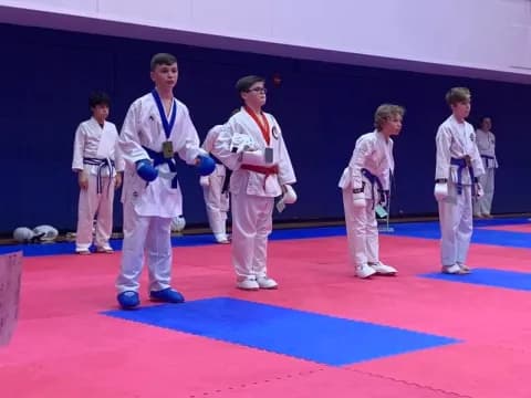 a group of people in karate uniforms