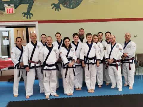 a group of people in white karate uniforms
