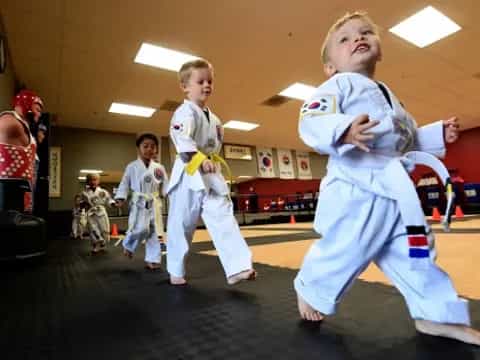 a group of kids in karate uniforms