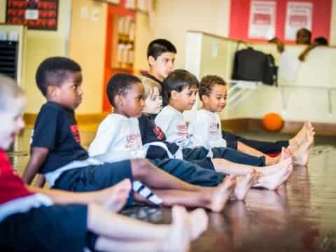 a group of boys sitting on the floor
