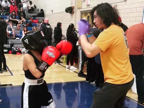 a group of people in a boxing ring