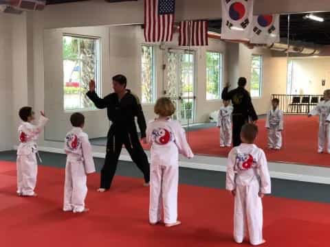 a group of kids in karate uniforms