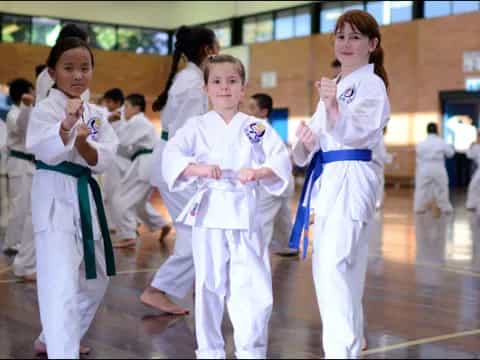 a group of girls in karate uniforms