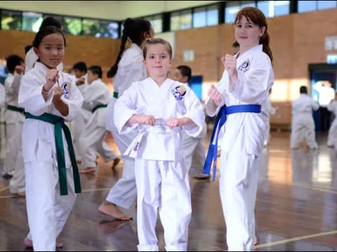 a group of girls in karate uniforms