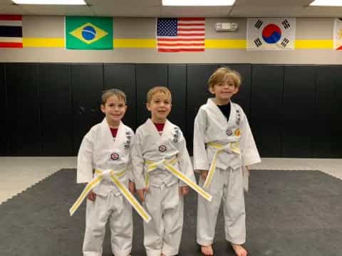 a group of kids in karate uniforms