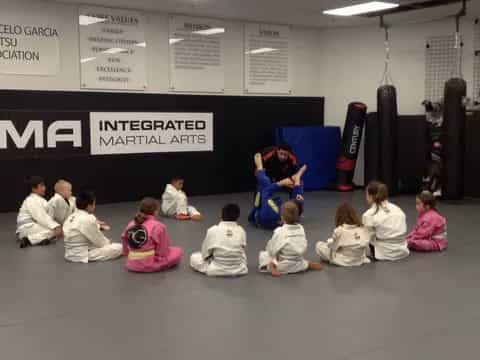 a group of children sitting on the floor in front of a person