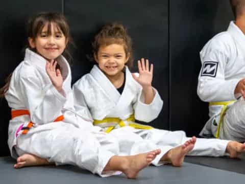 a few young girls in karate uniforms