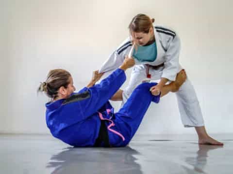 a woman and a man doing martial arts