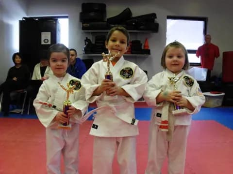 a group of girls in karate uniforms