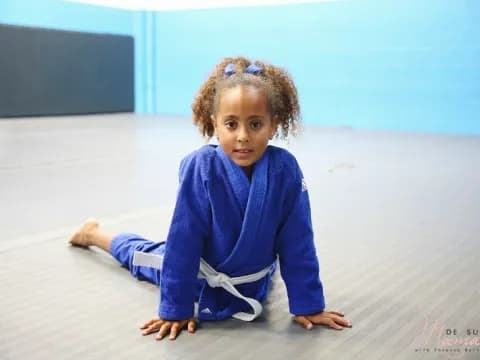 a little girl sitting on the floor