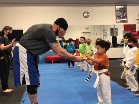 a person teaching children how to play