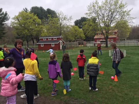 a group of children playing in a field