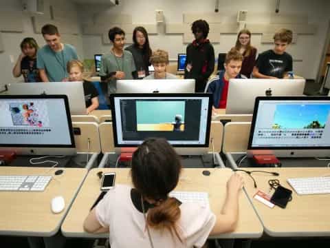 a group of people in a room with computers