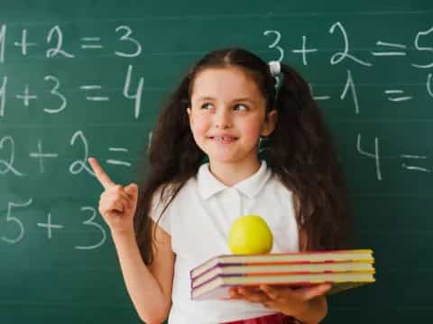 a girl holding a ball and a ball in front of her