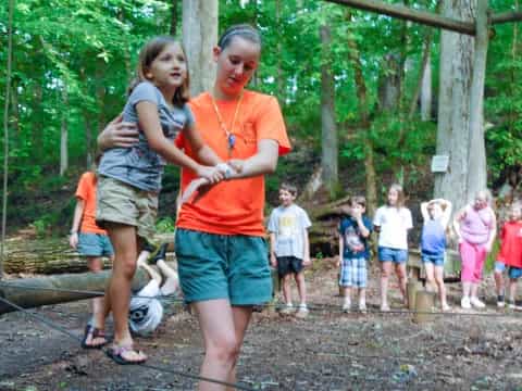 a group of children playing in the woods