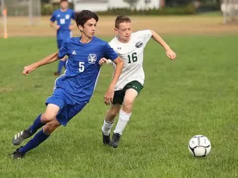 a couple of young men playing football