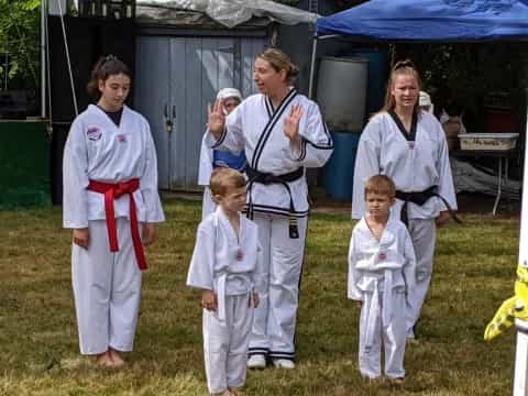 a group of people in white karate uniforms