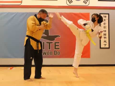 a man and woman in karate uniforms