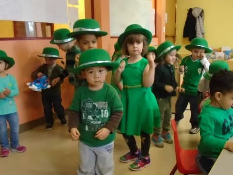 a group of children wearing green hats