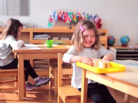 a few young girls sitting at a table