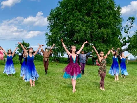 a group of people dancing in a field