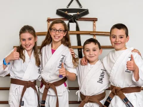 a group of people wearing white karate uniforms