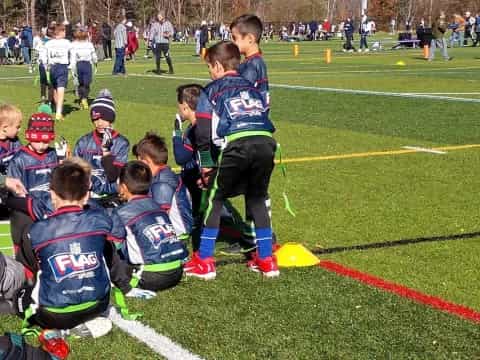 a group of kids sitting on the grass