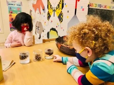 a young girl and a young girl painting on a table