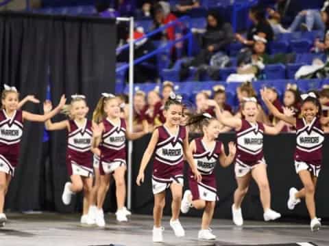 a group of cheerleaders on a track