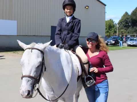 a man on a horse with a woman standing next to him