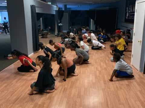 a group of people kneeling on the floor
