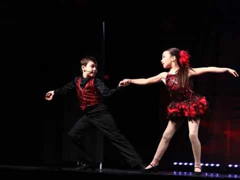 a man and woman dancing on a stage
