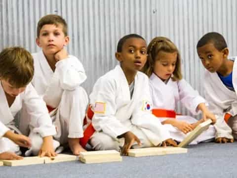 a group of children in white uniforms