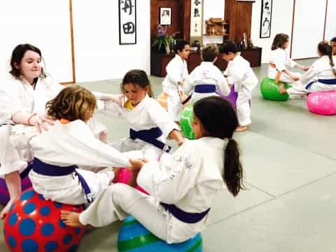 a group of children in white karate uniforms