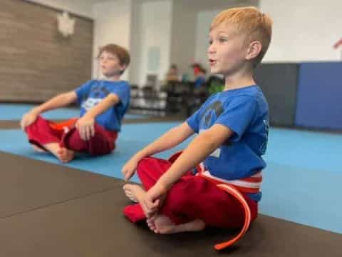 a couple of boys sitting on the floor