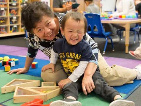 a couple of kids playing on the floor