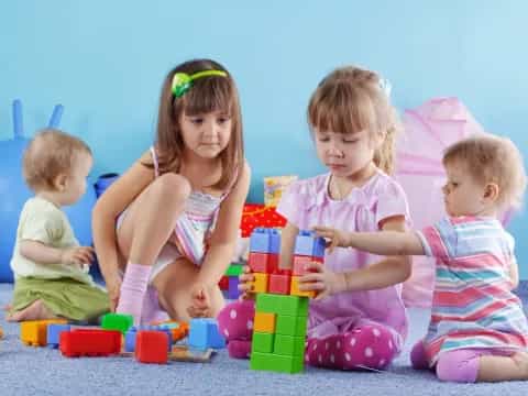 a group of children sitting on the floor with toys