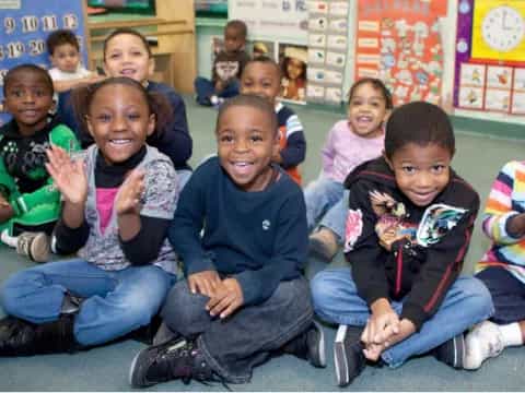 a group of children sitting on the floor